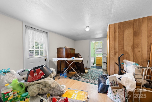 bedroom featuring wood finished floors, a textured ceiling, multiple windows, and ensuite bathroom