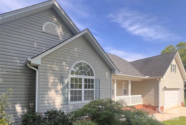 318 Linsbury Ct, Gastonia, NC 28056 - view of side of property featuring a porch, a garage, concrete driveway, and roof with shingles