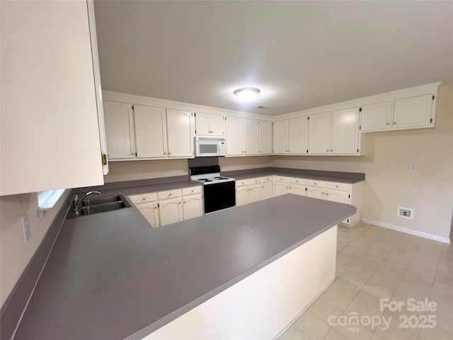 318 Linsbury Ct, Gastonia, NC 28056 - kitchen featuring white microwave, electric stove, a sink, a peninsula, and baseboards
