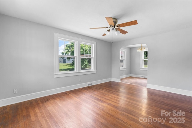 2336 32nd St NE, Hickory, NC 28601 - spare room with healthy amount of natural light, arched walkways, a chandelier, and wood finished floors