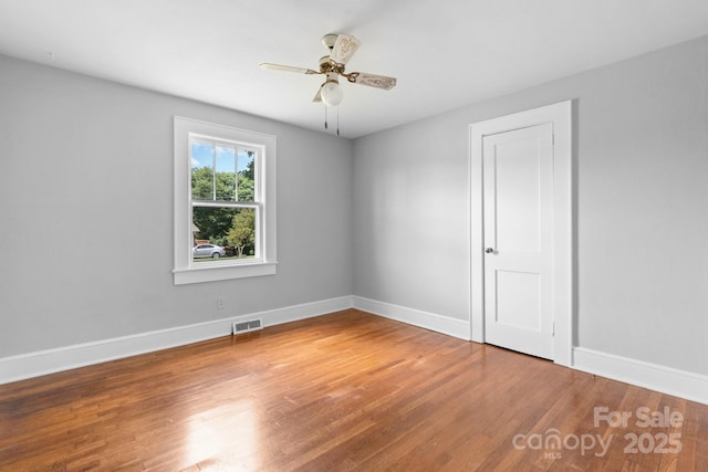 2336 32nd St NE, Hickory, NC 28601 - spare room with wood finished floors, baseboards, and ceiling fan