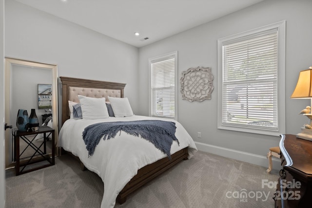 carpeted bedroom with baseboards, multiple windows, and recessed lighting