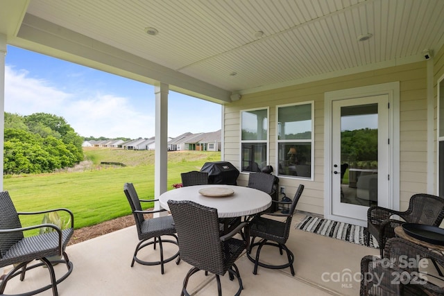 view of patio featuring outdoor dining area and a grill