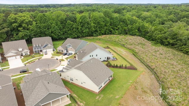aerial view of residential area featuring a heavily wooded area