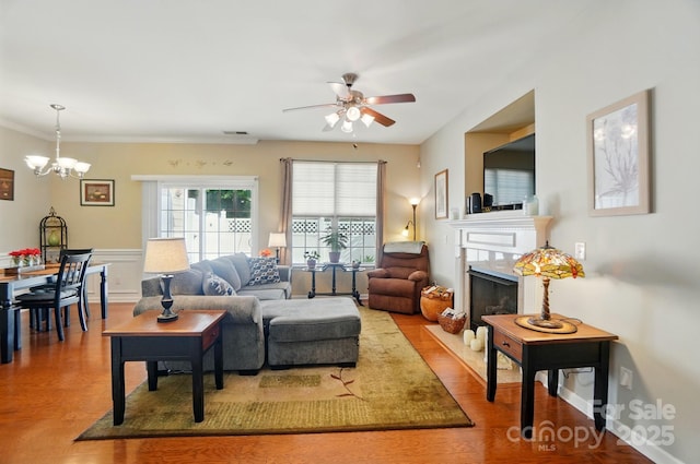 541 River Park Rd, Belmont, NC 28012 - living room with ceiling fan, wood finished floors, a premium fireplace, a chandelier, and ornamental molding