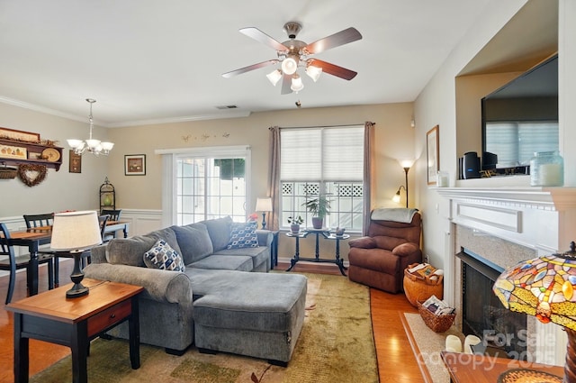 541 River Park Rd, Belmont, NC 28012 - living room featuring a premium fireplace, ceiling fan, wood finished floors, a chandelier, and wainscoting