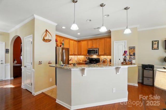 541 River Park Rd, Belmont, NC 28012 - kitchen with appliances with stainless steel finishes, arched walkways, ornamental molding, wood finished floors, and decorative backsplash