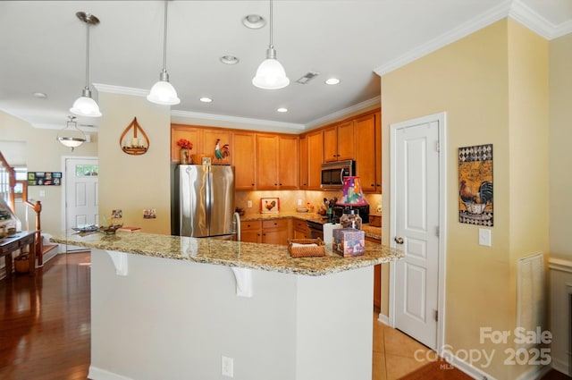 541 River Park Rd, Belmont, NC 28012 - kitchen with stainless steel appliances, a breakfast bar area, decorative backsplash, crown molding, and light stone countertops