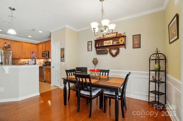 541 River Park Rd, Belmont, NC 28012 - dining room with a chandelier, light wood-style floors, ornamental molding, recessed lighting, and wainscoting