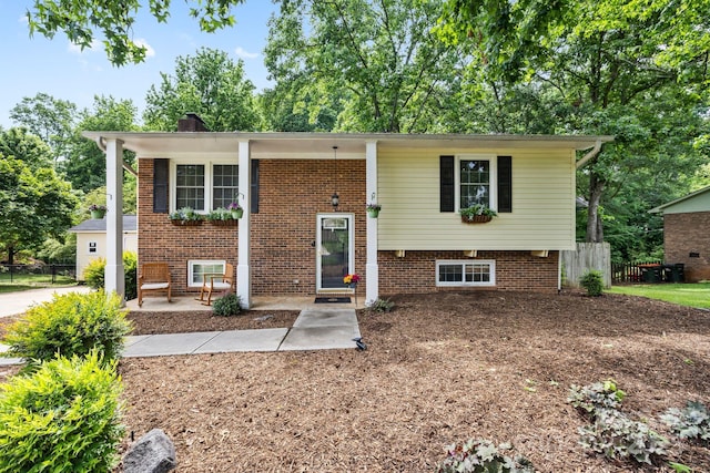 206 Pelham Ln, Fort Mill, SC 29715 - bi-level home featuring fence, a chimney, and brick siding