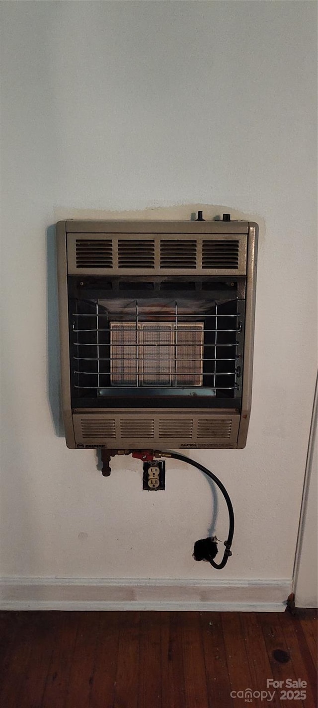 7881 Us-25/70 Hwy, Marshall, NC 28753 - detailed view of heating unit, baseboards, and wood finished floors