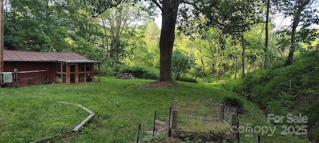 7881 Us-25/70 Hwy, Marshall, NC 28753 - view of grassy yard featuring an outdoor structure and a forest view