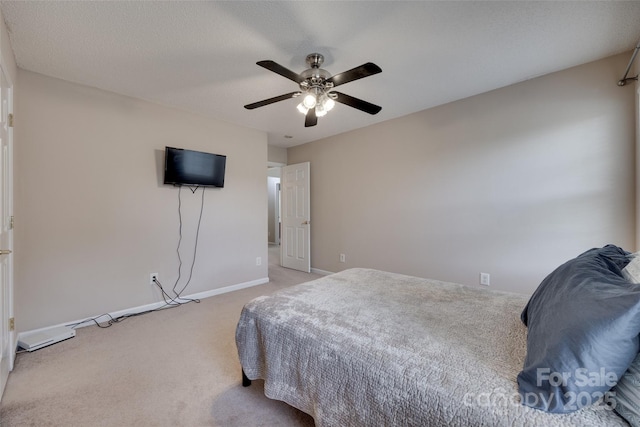 bedroom with light carpet, baseboards, and a ceiling fan