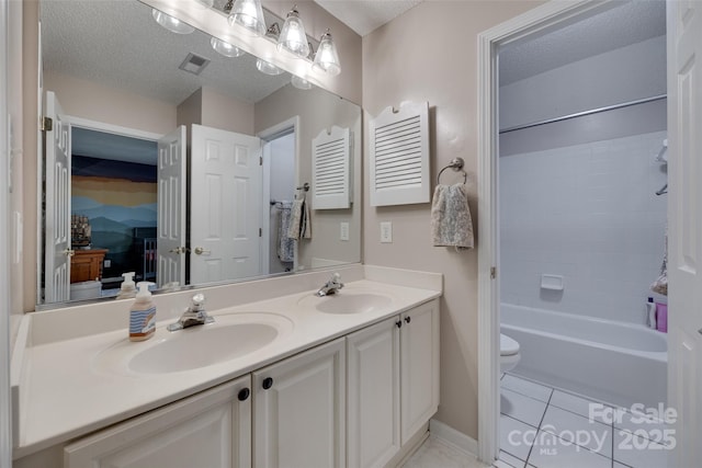 full bathroom featuring tile patterned floors, toilet, double vanity, tub / shower combination, and a textured ceiling