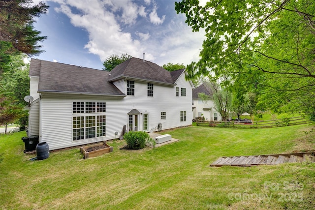 rear view of property with roof with shingles