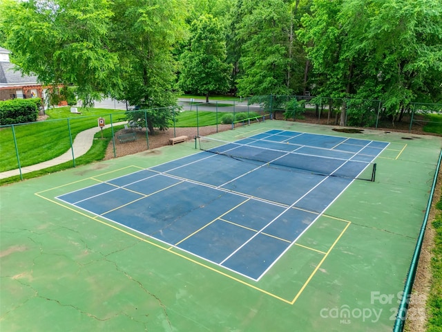 view of tennis court featuring fence