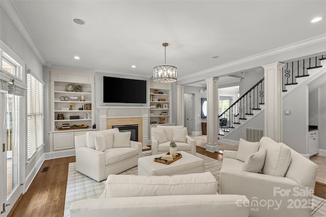 9831 Sedgefield Dr, Waxhaw, NC 28173 - living area with ornamental molding, plenty of natural light, ornate columns, baseboards, and recessed lighting