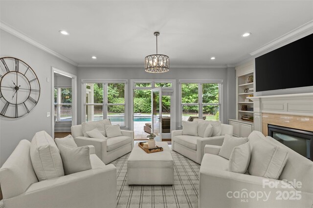 9831 Sedgefield Dr, Waxhaw, NC 28173 - living room with recessed lighting, a fireplace, plenty of natural light, a chandelier, and built in features