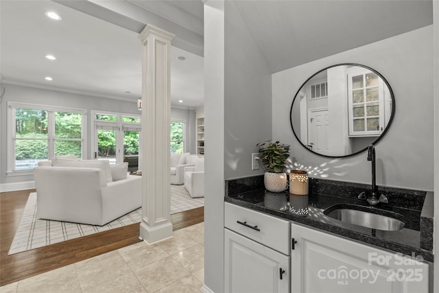 9831 Sedgefield Dr, Waxhaw, NC 28173 - bar area with a sink, healthy amount of natural light, light wood-style flooring, decorative columns, and recessed lighting