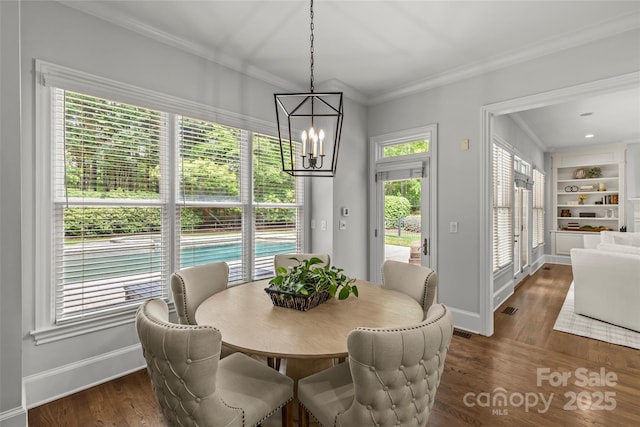 9831 Sedgefield Dr, Waxhaw, NC 28173 - dining area with crown molding, baseboards, a chandelier, and dark wood-style flooring