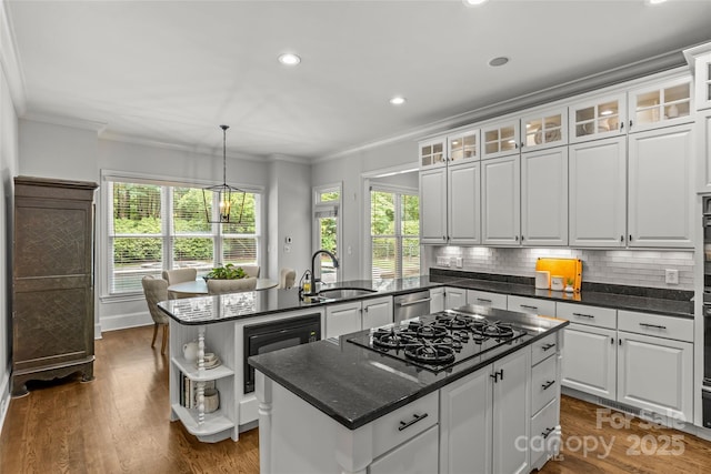 9831 Sedgefield Dr, Waxhaw, NC 28173 - kitchen with black appliances, crown molding, a kitchen island, plenty of natural light, and white cabinets
