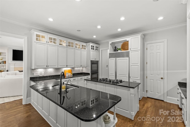 9831 Sedgefield Dr, Waxhaw, NC 28173 - kitchen with a sink, ornamental molding, a peninsula, a kitchen island, and white cabinetry