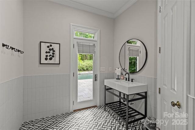 9831 Sedgefield Dr, Waxhaw, NC 28173 - bathroom with wainscoting, ornamental molding, and a sink