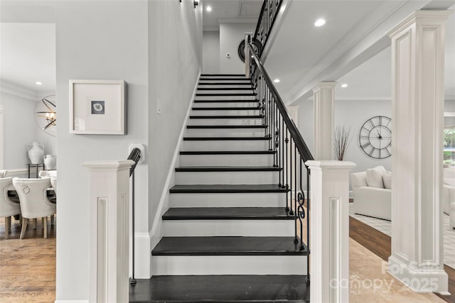 9831 Sedgefield Dr, Waxhaw, NC 28173 - stairs featuring ornamental molding, decorative columns, wood finished floors, and recessed lighting