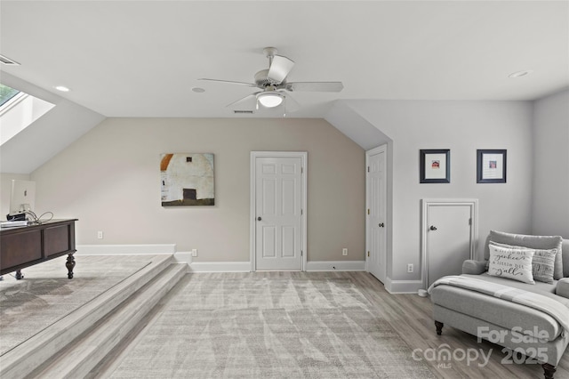 9831 Sedgefield Dr, Waxhaw, NC 28173 - sitting room with light wood-type flooring, ceiling fan, lofted ceiling, baseboards, and a skylight