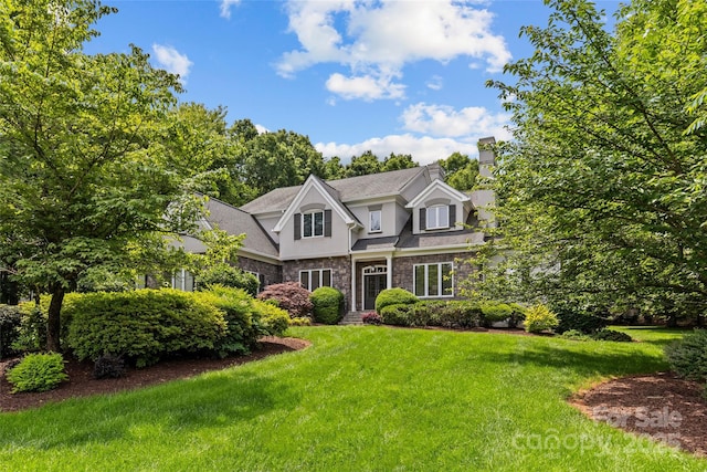 9831 Sedgefield Dr, Waxhaw, NC 28173 - view of front of property with stone siding, a front lawn, a chimney, and stucco siding