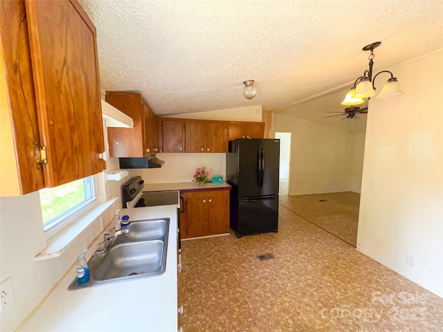 19 Harkins Ln, Marshall, NC 28753 - kitchen with freestanding refrigerator, brown cabinetry, a sink, a textured ceiling, and lofted ceiling