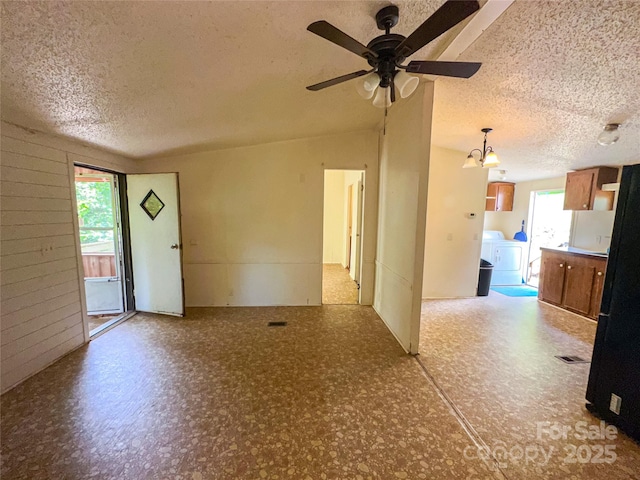 19 Harkins Ln, Marshall, NC 28753 - unfurnished living room featuring a textured ceiling, healthy amount of natural light, washer / clothes dryer, and ceiling fan