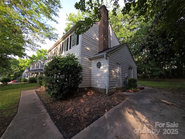 view of side of home featuring a chimney