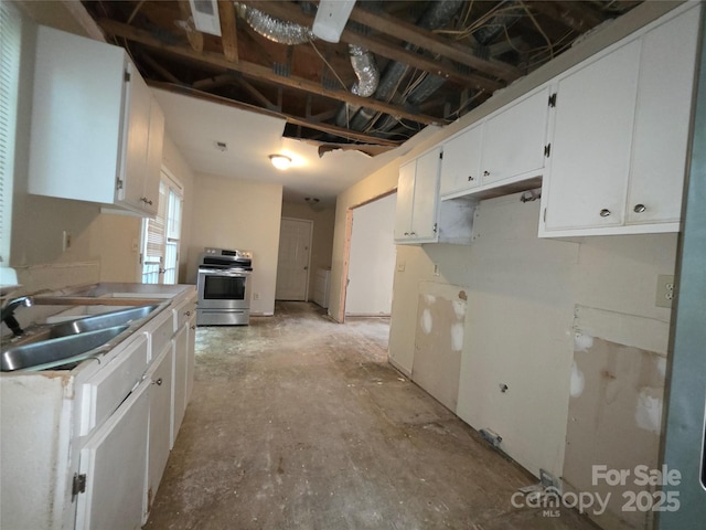 kitchen with stainless steel electric stove, a sink, white cabinetry, and light countertops