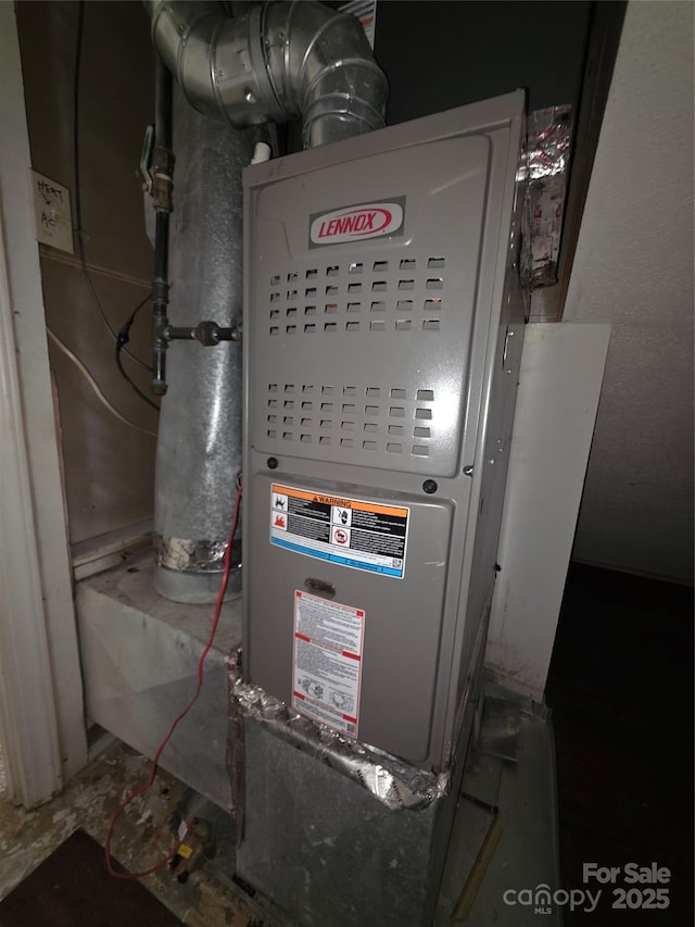 utility room featuring heating unit