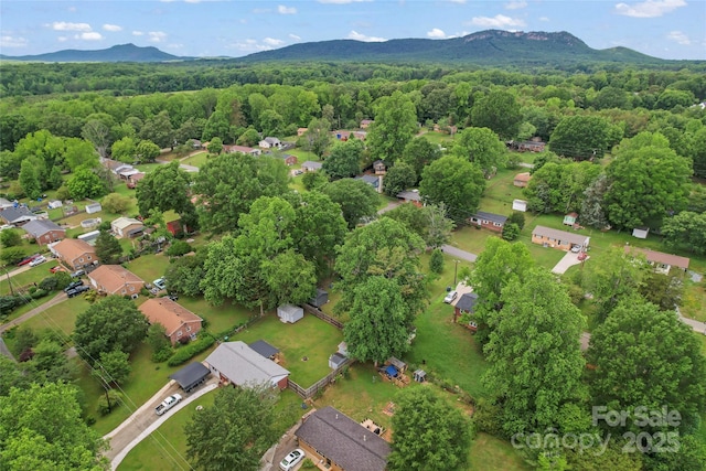 2401 Woodleaf Dr, Gastonia, NC 28052 - aerial view of property and surrounding area with a mountain backdrop, a heavily wooded area, and nearby suburban area