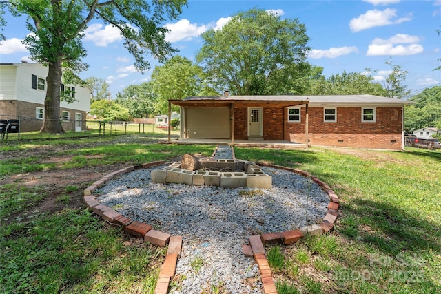 2401 Woodleaf Dr, Gastonia, NC 28052 - rear view of property featuring a fire pit, brick siding, crawl space, and a patio area
