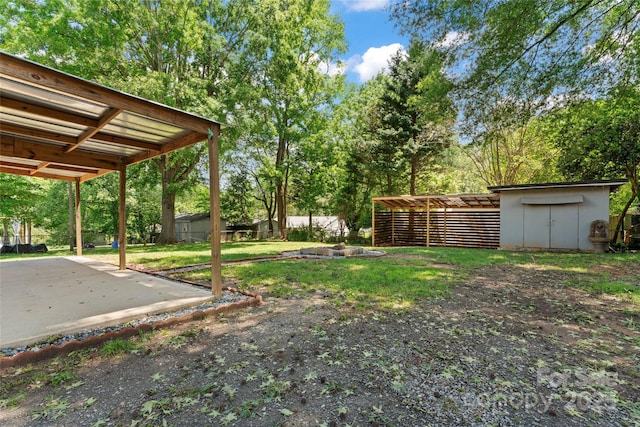 2401 Woodleaf Dr, Gastonia, NC 28052 - view of green lawn with a storage unit, an outbuilding, and view of scattered trees