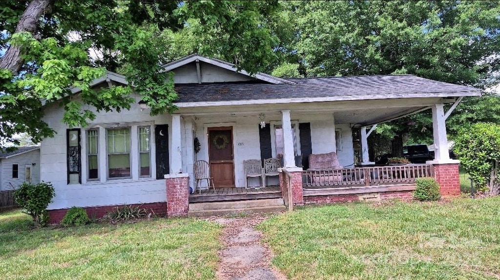 1313 Maiden Rd E, Maiden, NC 28650 - bungalow-style home featuring covered porch, a front lawn, and roof with shingles
