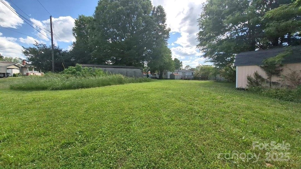 1313 Maiden Rd E, Maiden, NC 28650 - view of green lawn with a shed