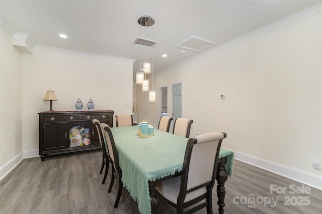131 Swink St SW, Concord, NC 28027 - dining space featuring wood finished floors, ornamental molding, baseboards, attic access, and recessed lighting