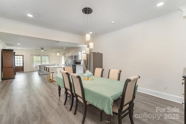 131 Swink St SW, Concord, NC 28027 - dining space featuring ornamental molding, wood finished floors, baseboards, recessed lighting, and a ceiling fan