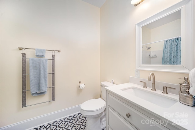 131 Swink St SW, Concord, NC 28027 - full bath with toilet, vanity, curtained shower, and baseboards