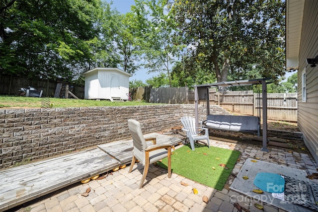 131 Swink St SW, Concord, NC 28027 - view of patio featuring a shed, an outbuilding, and a fenced backyard