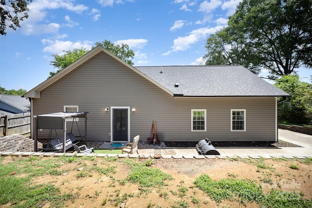 131 Swink St SW, Concord, NC 28027 - back of house featuring a shingled roof, fence, and a patio