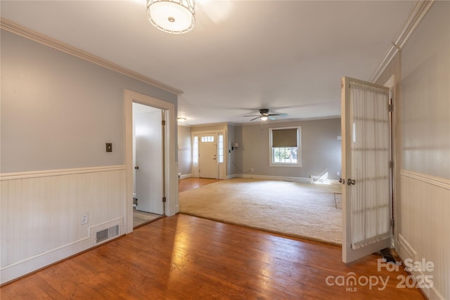 80 Pine St, Badin, NC 28009 - unfurnished room featuring ornamental molding, wood finished floors, wainscoting, ceiling fan, and baseboards