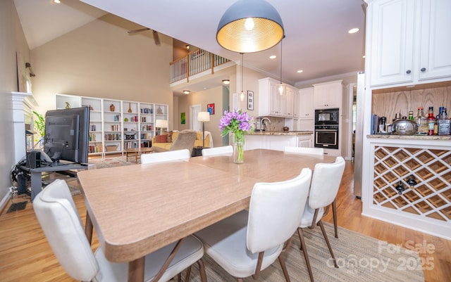 dining space with light wood-type flooring and recessed lighting