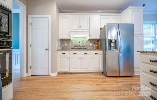 kitchen with black appliances, crown molding, tasteful backsplash, white cabinets, and stone countertops