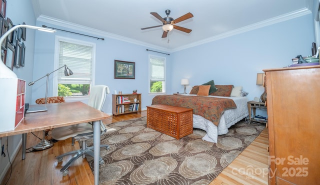 bedroom with wood finished floors, crown molding, and an office area