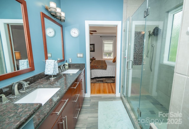 bathroom with ensuite bath, a stall shower, and double vanity